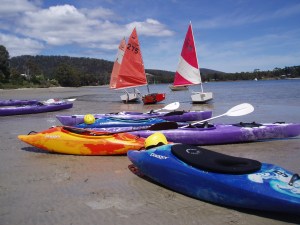sailing dinghies and kayaks ready to launch into spring and summer
